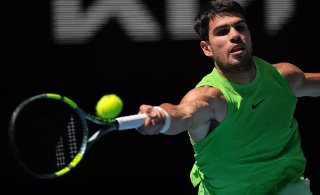 Carlos Alcaraz of Spain plays a forehand return to Tommy Paul of the U.S. during their fourth round match at the Australian Open tennis championship in Melbourne, Australia, Sunday, Jan. 25, 2026. (AP Photo/Dita Alangkara)