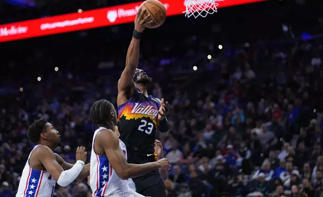 Phoenix Suns' Jordan Goodwin, right, goes up for a shot against Philadelphia 76ers' Tyrese Maxey during the first half of an NBA basketball game Tuesday, Jan. 20, 2026, in Philadelphia. (AP Photo/Matt Slocum)