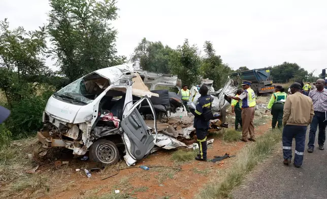 Police inspects the scene of a collision between a truck and a minibus carrying school children in Vanderbijlpark, South of Johannesburg, South Africa, Monday, Jan. 19, 2026. (AP Photo)