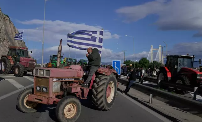 Farmers block the Chalkida Bridge with tractors during a protest over delays in European Union–backed agricultural subsidy payments, on Evia island, Greece, Thursday, Jan. 8, 2026. (AP Photo/Thanassis Stavrakis)