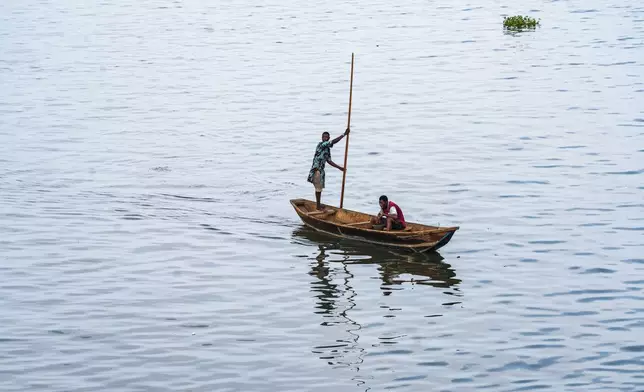 Residents on a boat on the Lagos Lagoon on Saturday, Dec. 6, 2025. (AP Photo/Grace Ekpu)