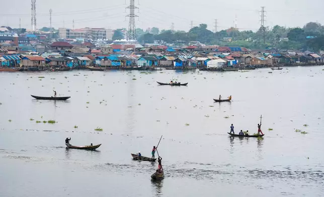 Fishermen in the lagoon in Lagos, Nigeria, on Saturday, Dec. 6, 2025. (AP Photo/Grace Ekpu)