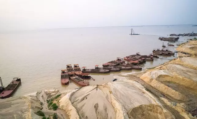 Aerial view of heaps of sand and dredging equipment in the busy Ajah area of Lagos, Nigeria, on Saturday, Dec. 6, 2025. Lagos is in constant construction. Roads, bridges and housing estates are rising daily on reclaimed waterfronts as the city's rich displace many of its poor. (AP Photo/Grace Ekpu)