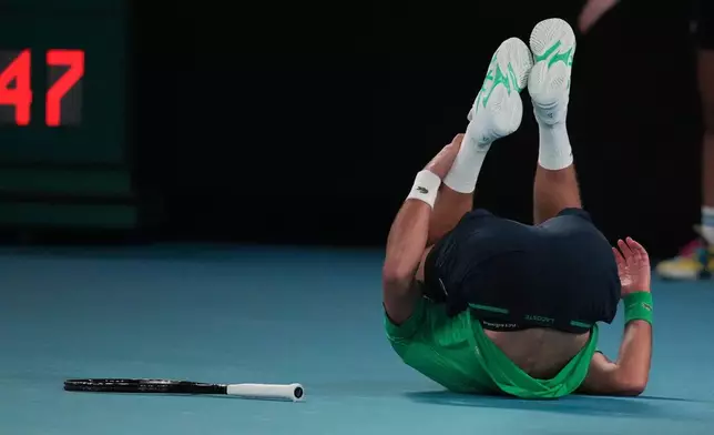 Novak Djokovic of Serbia falls during his third round match against Botic van de Zandschulp of the Netherlands at the Australian Open tennis championship in Melbourne, Australia, Saturday, Jan. 24, 2026. (AP Photo/Dita Alangkara)