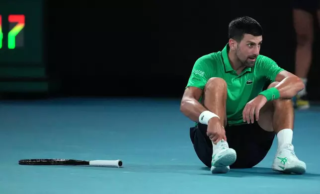 Novak Djokovic of Serbia reacts after a fall during his third round match against Botic van de Zandschulp of the Netherlands at the Australian Open tennis championship in Melbourne, Australia, Saturday, Jan. 24, 2026. (AP Photo/Dita Alangkara)