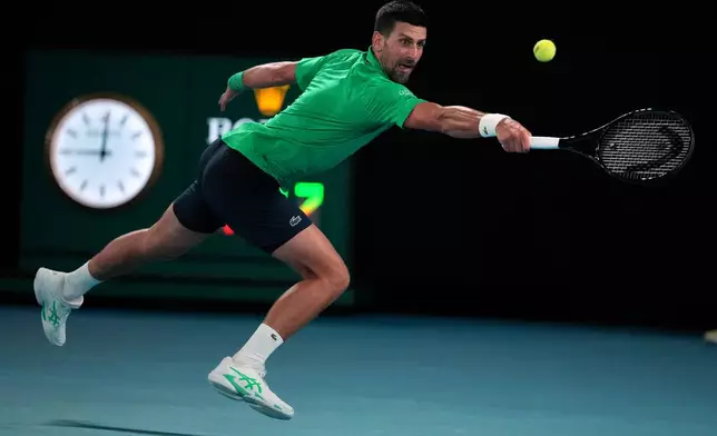 Novak Djokovic of Serbia plays a backhand return to Botic van de Zandschulp of the Netherlands during their third round match at the Australian Open tennis championship in Melbourne, Australia, Saturday, Jan. 24, 2026. (AP Photo/Dita Alangkara)