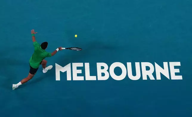 Novak Djokovic of Serbia plays a forehand return to Botic van de Zandschulp of the Netherlands during their third round match at the Australian Open tennis championship in Melbourne, Australia, Saturday, Jan. 24, 2026. (AP Photo/Dar Yasin)