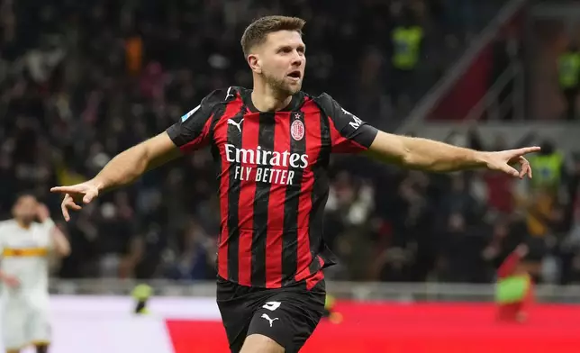 AC Milan's Niclas Fullkrug celebrates after scoring his side's first goal during the Serie A soccer match between AC Milan and Lecce in Milan, Italy, Sunday, Jan. 18, 2026. (AP Photo/Antonio Calanni)