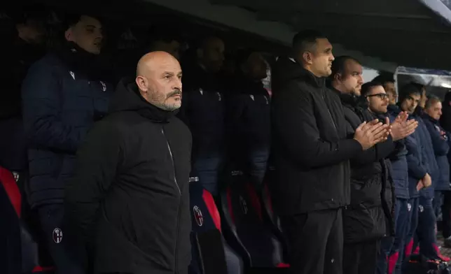 Bologna's head coach Vincenzo Italiano looks during a minute of silence to honor late Fiorentina President Rocco Commisso during the Serie A soccer match between Bologna and Fiorentina, in Bologna, Italy, Sunday, Jan. 18, 2026. (Massimo Paolone/LaPresse via AP)