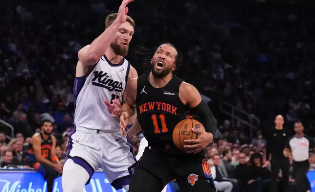 New York Knicks' Jalen Brunson (11) passes away from Sacramento Kings' Dylan Cardwell (32) during the first half of an NBA basketball game Tuesday, Jan. 27, 2026, in New York. (AP Photo/Frank Franklin II)
