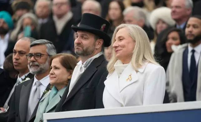 Virginia Gov. Abigail Spanberger sits with her husband Adam Spanberger during inaugural ceremonies at the Capitol in Richmond Va., Saturday Jan. 17, 2026. (AP Photo/Steve Helber, Pool)