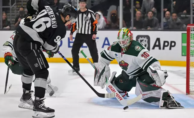 Minnesota Wild goaltender Jesper Wallstedt blocks a shot by Los Angeles Kings left wing Andrei Kuzmenko during the second period of an NHL hockey game, Saturday, Jan. 3, 2026, in Los Angeles. (AP Photo/Jayne Kamin-Oncea)