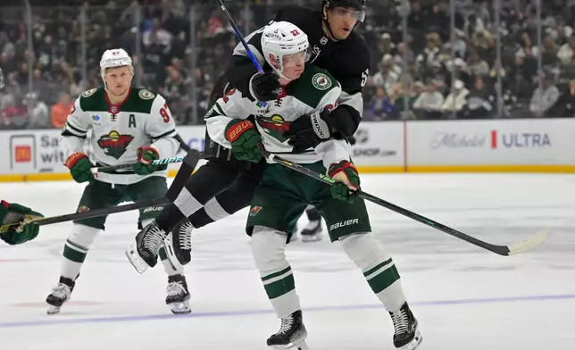 Los Angeles Kings right wing Quinton Byfield collides with Minnesota Wild right wing Danila Yurov (22) during the second period of an NHL hockey game, Saturday, Jan. 3, 2026, in Los Angeles. (AP Photo/Jayne Kamin-Oncea)