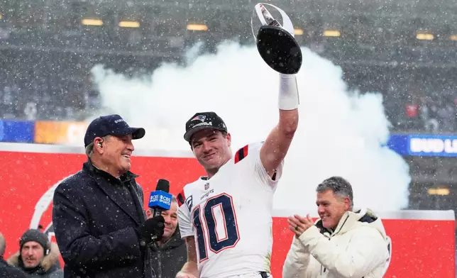 New England Patriots quarterback Drake Maye celebrates with the trophy after the AFC Championship NFL football game between the Denver Broncos and the New England Patriots, Sunday, Jan. 25, 2026, in Denver. (AP Photo/John Locher)