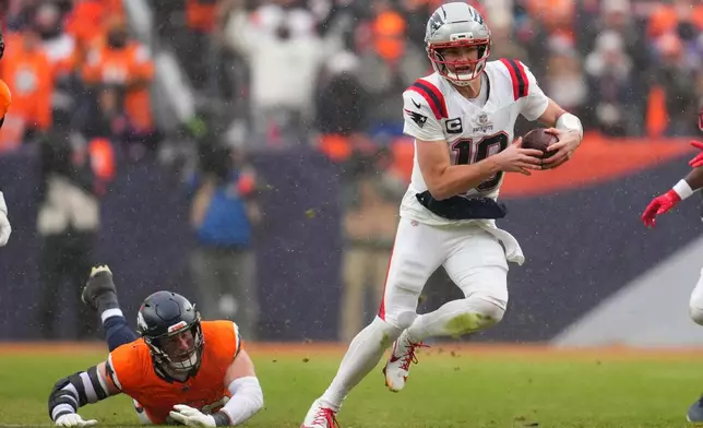 New England Patriots quarterback Drake Maye runs against the Denver Broncos during the second the half of the AFC Championship NFL football game, Sunday, Jan. 25, 2026, in Denver. (AP Photo/Garrett W. Ellwood)
