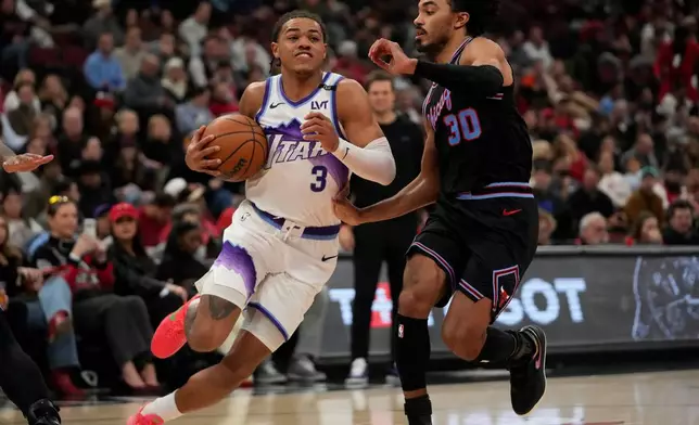 Chicago Bulls guard Tre Jones (30), right, guards Utah Jazz guard Keyonte George (3) during the second half of an NBA basketball game Wednesday, Jan. 14, 2026, in Chicago. (AP Photo/Erin Hooley)