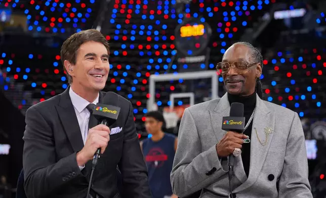 Debuting as an NBA analyst, Snoop Dogg, right, records a segment with Terry Gannon before an NBA basketball game between the Los Angeles Clippers and the Golden State Warriors Monday, Jan. 5, 2026, in Inglewood, Calif. (AP Photo/Jae C. Hong)
