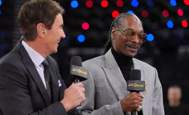 Debuting as an NBA analyst, Snoop Dogg, right, records a segment with Terry Gannon before an NBA basketball game between the Los Angeles Clippers and the Golden State Warriors on Monday, Jan. 5, 2026, in Inglewood, Calif. (AP Photo/Jae C. Hong)
