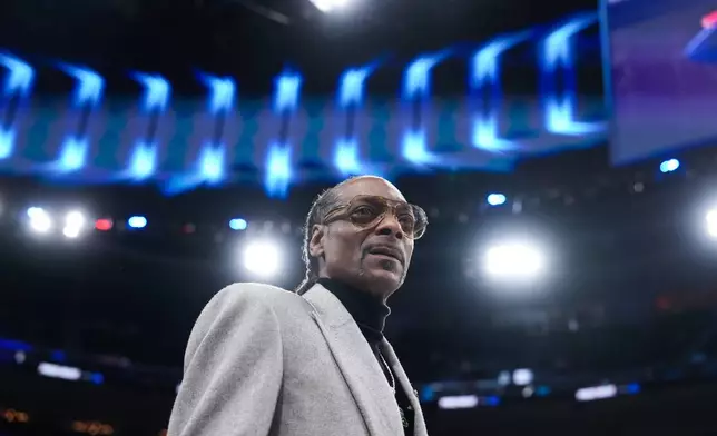 NBA analyst Snoop Dogg stands on the court before an NBA basketball game between the Los Angeles Clippers and the Golden State Warriors, Monday, Jan. 5, 2026, in Inglewood, Calif. (AP Photo/Jae C. Hong)