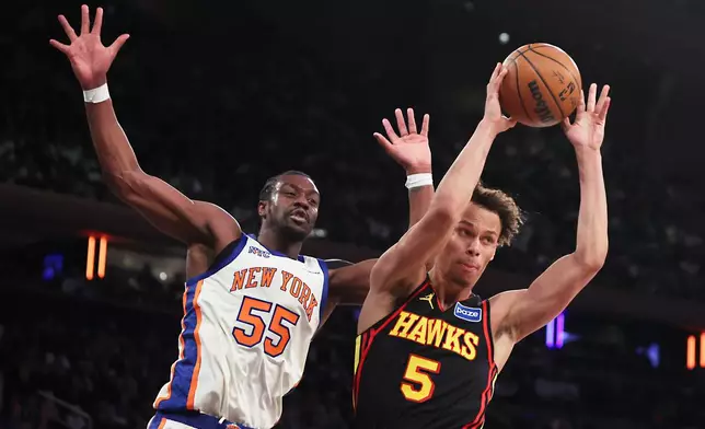 Atlanta Hawks guard Dyson Daniels (5) passes the ball around New York Knicks center Ariel Hukporti (55) during second half of an NBA basketball game, Friday, Jan. 2, 2026, in New York. (AP Photo/Heather Khalifa)