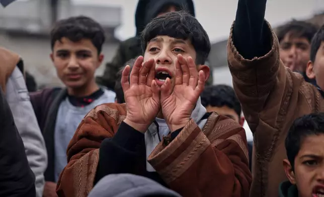 Local youth cheer as Syrian government troops take control of the town from the Kurdish-led, U.S.-backed Syrian Democratic Forces (SDF) in Tabqa, eastern Syria, Sunday, Jan. 18, 2026. (AP Photo/Ghaith Alsayed)