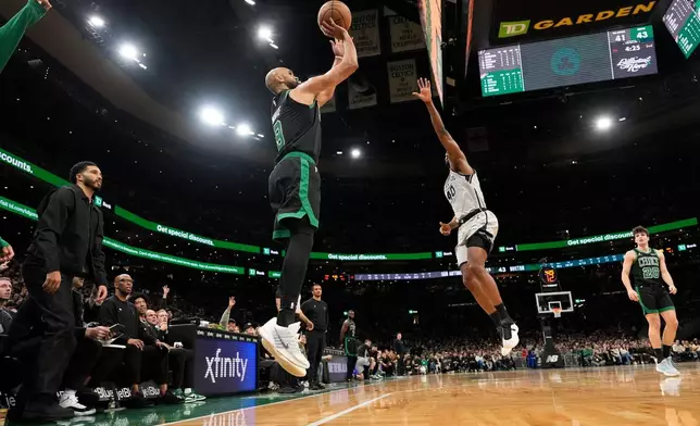 Boston Celtics guard Derrick White (9) soots over San Antonio Spurs forward Harrison Barnes (40) during the first half of an NBA basketball game, Saturday, Jan. 10, 2026, in Boston. (AP Photo/Robert F. Bukaty)