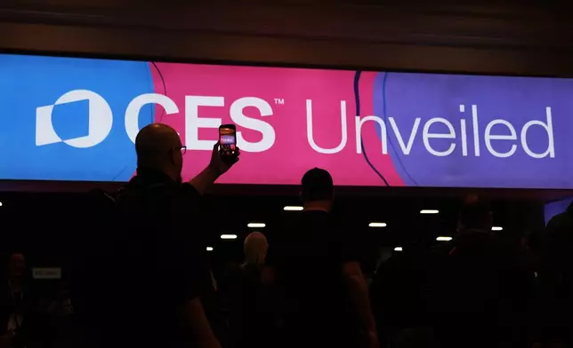 People arrive at the CES Unveiled tech show Sunday, Jan. 4, 2026, in Las Vegas. (AP Photo/Abbie Parr)