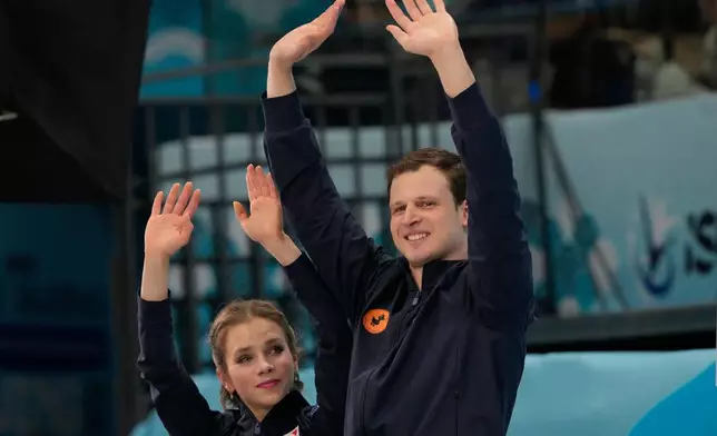 Gold medalists Alisa Efimova and Misha Mitrofanov of the United States react after the Pairs Free Skating of the ISU Four Continents Figure Skating Championships in Beijing, China, Saturday, Jan. 24, 2026. (AP Photo/Vincent Thian)