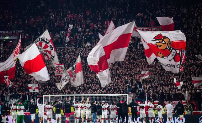 Stuttgart players celebrate with their fans after the Bundesliga soccer match between VfB Stuttgart and Eintracht Frankfurt in Stuttgart, Germany, Tuesday Jan. 13, 2026. (Tom Weller/dpa via AP)
