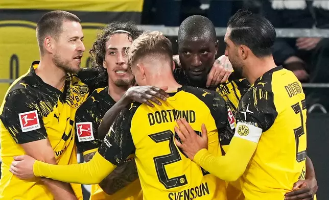 Dortmund's Serhou Guirassy, second right, celebrates with teammates after scoring the third goal against Werder Bremen during the German Bundesliga soccer match between Borussia Dortmund and Werder Bremen in Dortmund, Germany, on Tuesday, Jan. 13, 2026. (AP Photo/Martin Meissner)