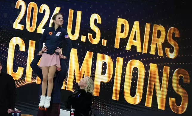 Misha Mitrofanov lifts his partner Alisa Efimova after they took first place to win the pairs free skating competition at the U.S. Figure Skating Championships, Friday, Jan. 9, 2026, in St. Louis. (AP Photo/Stephanie Scarbrough)