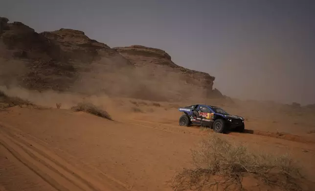 Driver Mitch Guthrie and co-driver Kellon Walsh compete during the third stage of the Dakar Rally with a start and finish in Alula, Saudi Arabia, Tuesday, Jan. 6, 2026. (AP Photo/Thibault Camus)