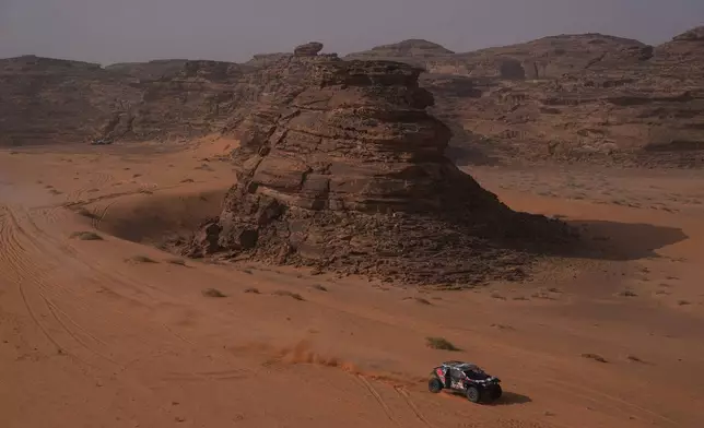 Driver Sebastien Loeb and co-driver Edouard Boulanger compete during the third stage of the Dakar Rally with a start and finish in Alula, Saudi Arabia, Tuesday, Jan. 6, 2026. (AP Photo/Thibault Camus)