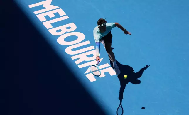 Lorenzo Musetti of Italy plays a forehand return to Tomas Machac of the Czech Republic during their third round match at the Australian Open tennis championship in Melbourne, Australia, Saturday, Jan. 24, 2026. (AP Photo/Asanka Brendon Ratnayake)