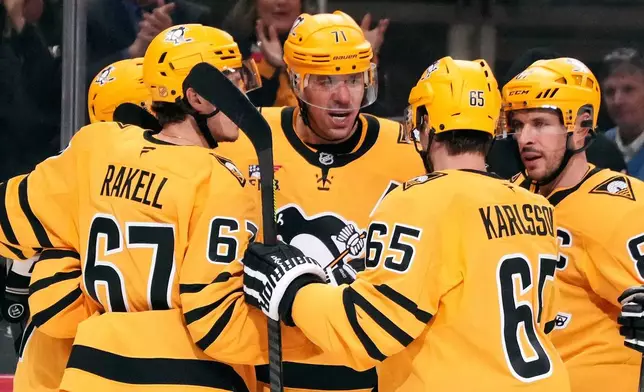 Pittsburgh Penguins' Evgeni Malkin (71) celebrates his goal during the second period of an NHL hockey game against the New Jersey Devils in Pittsburgh, Thursday, Jan. 8, 2026. (AP Photo/Gene J. Puskar)