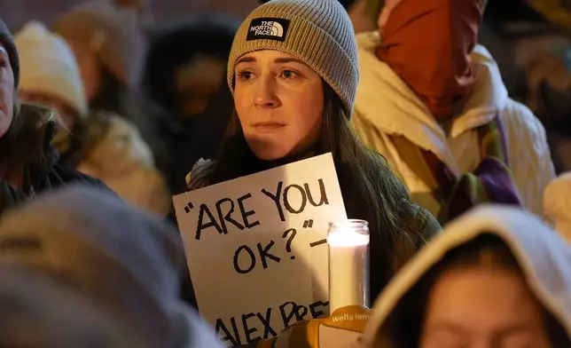 Attendees gather during a vigil where Alex Pretti was shot and killed by federal immigration enforcement in Minneapolis, on Wednesday, Jan. 28, 2026. (AP Photo/Adam Gray)
