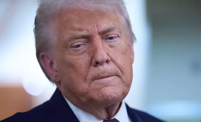 President Donald Trump speaks with reporters aboard Air Force One after leaving the World Economic Forum in Davos for Washington, Thursday, Jan. 22, 2026. (AP Photo/Evan Vucci)