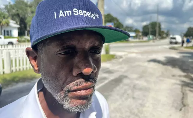 FILE - Jazz Watts, a resident of Sapelo Island, wears a hat that reads "I am Sapelo" outside the McIntosh County courthouse in Darien, Ga., on Friday, Sept. 20, 2024. (AP Photo/Russ Bynum, File)