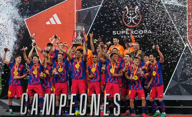Barcelona players celebrate after winning the Spanish Super Cup final soccer match against Real Madrid at King Abdullah Sports City Stadium in Jeddah, Saudi Arabia, Sunday, Jan. 11, 2026. (AP Photo/Altaf Qadri)