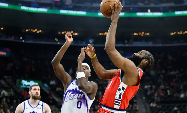 Los Angeles Clippers guard James Harden, right, shoots over Utah Jazz forward Taylor Hendricks (0) during the first half of an NBA basketball game, Thursday, Jan. 1, 2026, in Inglewood, Calif. (AP Photo/William Liang)