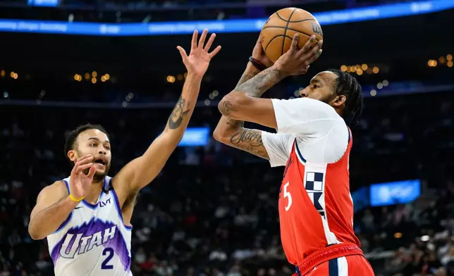 Los Angeles Clippers forward Derrick Jones Jr. (5) shoots while under pressure from Utah Jazz forward Kyle Anderson (2) during the first half of an NBA basketball game Thursday, Jan. 1, 2026, in Inglewood, Calif. (AP Photo/William Liang)