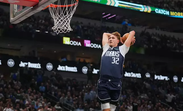 Dallas Mavericks forward Cooper Flagg dunks on the Philadelphia 76ers during the first half of an NBA basketball game Thursday, Jan. 1, 2026, in Dallas. (AP Photo/Julio Cortez)