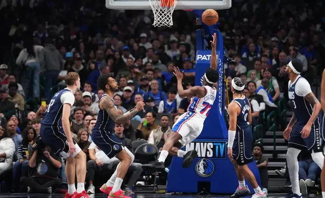 Philadelphia 76ers guard Vj Edgecombe (77) shoots the ball against the Dallas Mavericks during the first half of an NBA basketball game Thursday, Jan. 1, 2026, in Dallas. (AP Photo/Julio Cortez)
