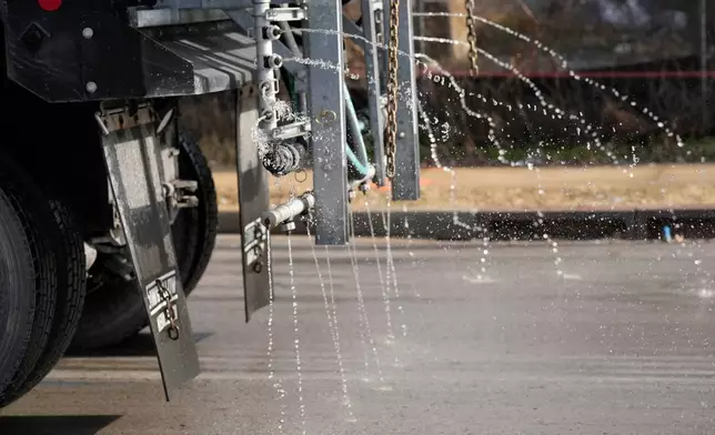 A Nashville Department of Transportation truck applies salt brine to a roadway Thursday, Jan. 22, 2026, in Nashville, Tenn., ahead of a winter storm expected to hit the state over the weekend. (AP Photo/George Walker IV)