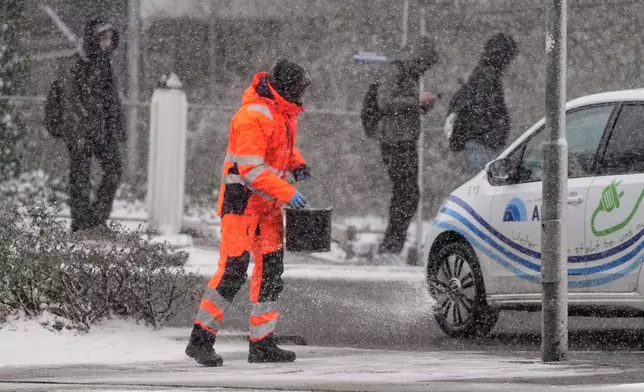FILE - Salt is spread on a street in Gelsenkirchen, Germany, Jan. 7, 2026. (AP Photo/Martin Meissner, File)