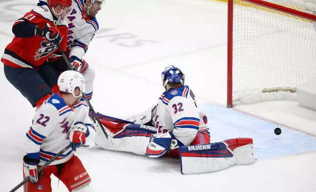 Washington Capitals center Aliaksei Protas (21) scores a goal past New York Rangers goaltender Jonathan Quick (32) during the third period of an NHL hockey game, Wednesday, Dec. 31, 2025, in Washington. (AP Photo/Nick Wass)