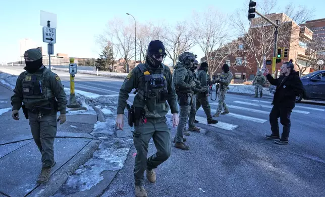 Federal immigration officers are seen Wednesday, Jan. 14, 2026, in Minneapolis. (AP Photo/Abbie Parr)