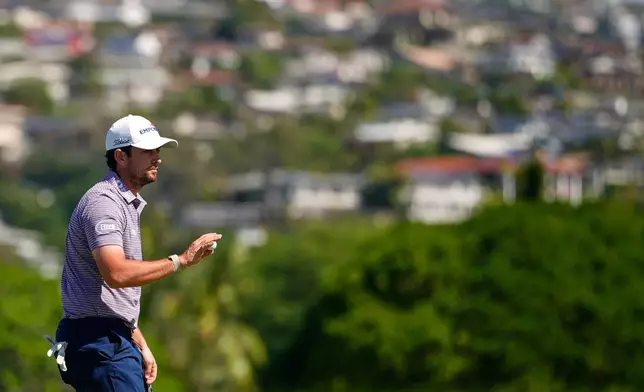 Davis Riley acknowledges the crowd on the 18th hole during the second round of the Sony Open golf event at the Waialae Country Club in Honolulu, Friday, Jan. 16, 2026. (AP Photo/Matt York)