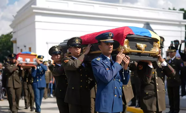 Military personnel carry the coffins of soldiers killed in the U.S. capture of Venezuelan President Nicolas Maduro and his wife, during a funeral in Caracas, Venezuela, Wednesday, Jan. 7, 2026. (AP Photo/Ariana Cubillos)