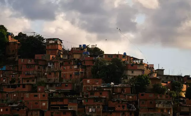 A kite flies over the Petare neighborhood of Caracas, Venezuela, Wednesday, Jan. 7, 2026. (AP Photo/Matias Delacroix)